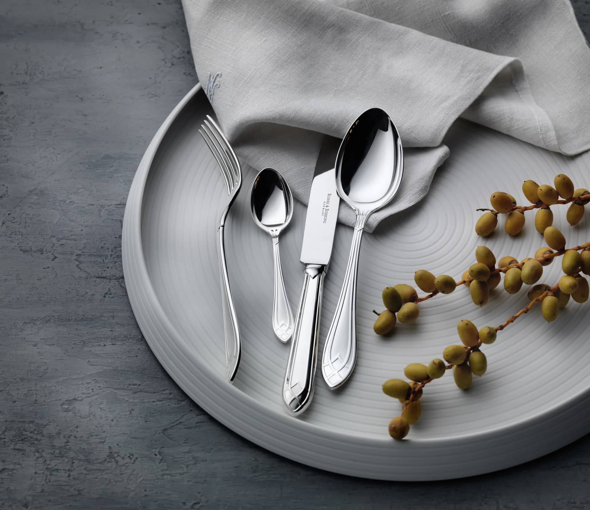 An array of elegant silver and gold-plated cutlery.