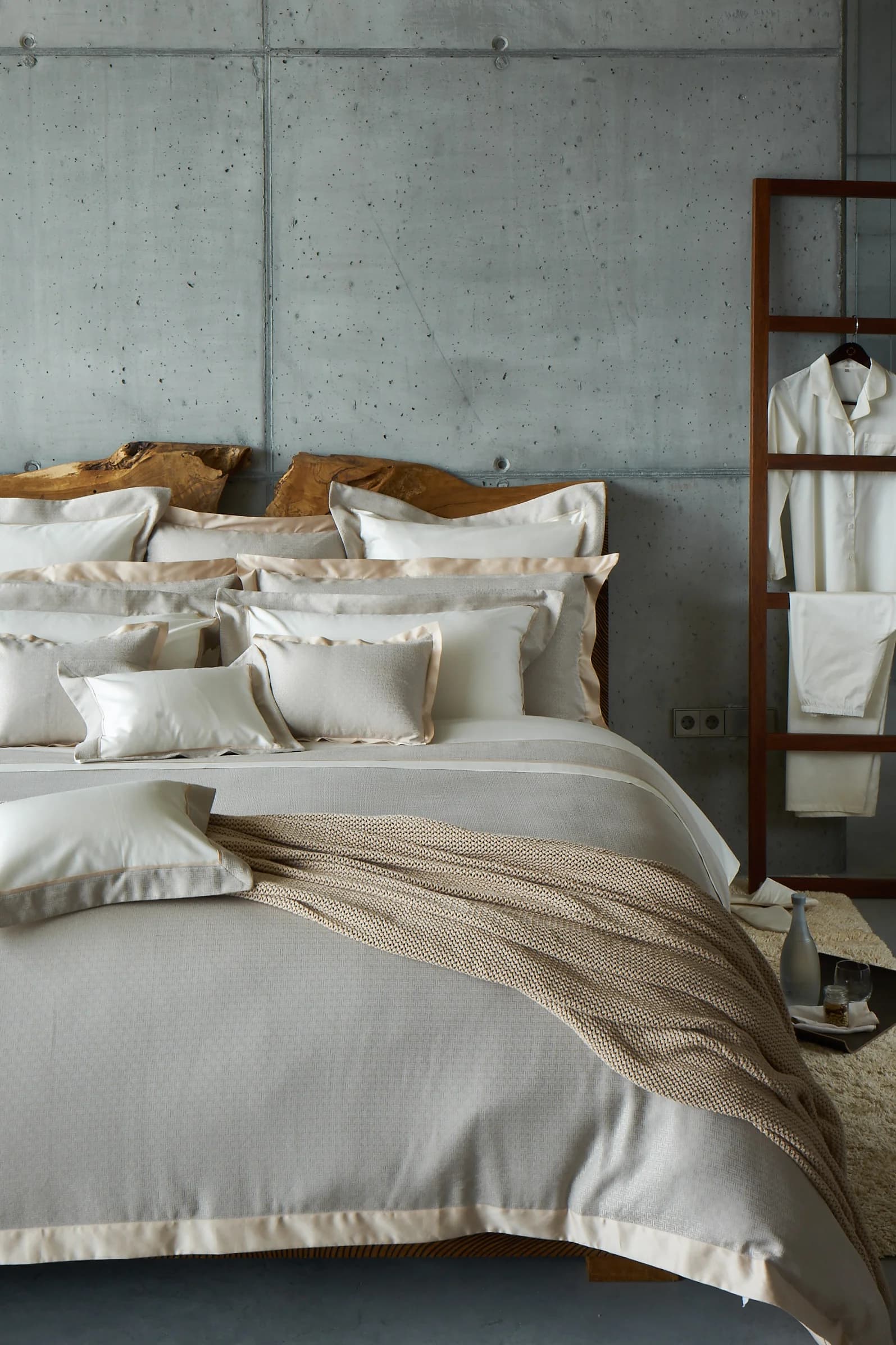 Close-up of neatly folded high-thread-count bed linens.